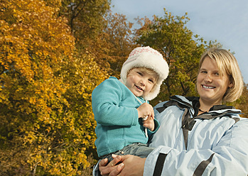 A joyful mother in Bavaria carries her smiling daughter in this heartwarming portrait - RNF000807