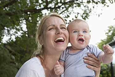 Germany, Bavaria, Munich, Mother and baby boy in garden, smiling - RBF000795