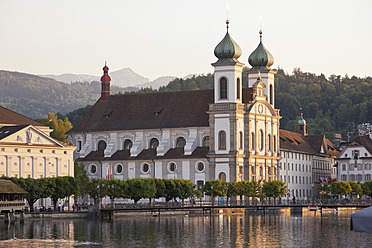 Switzerland, Lucerne, View of church with River Reuss and mountain in background - MSF002478