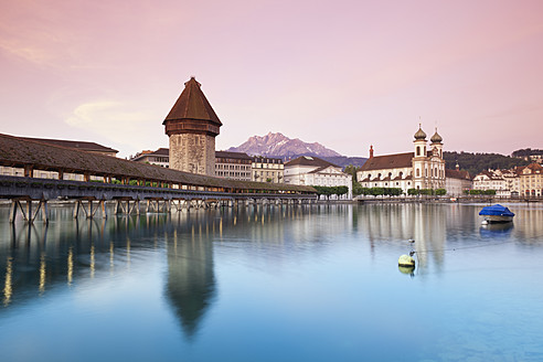 Switzerland, Lucerne, View of water tower, bridge and church in morning - MSF002490
