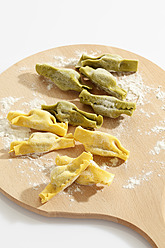 Candy shape pasta with flour on chopping board - CSF015479