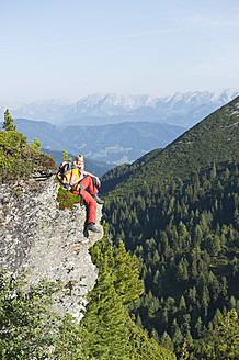 Austria, Salzburg, Hiker sitting on rock, portrait - HHF003768