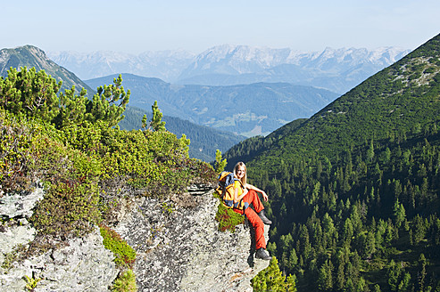 Austria, Salzburg, Hiker sitting on rock, portrait - HHF003769