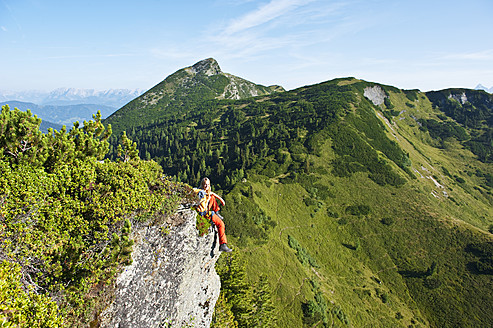 Austria, Salzburg, Hiker sitting on rock, portrait - HHF003770