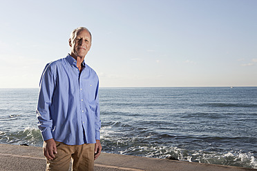 Spain, Mallorca, Senior man standing at sea shore, portrait - SKF000782