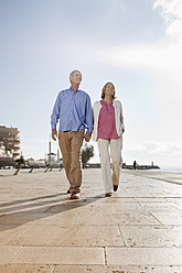 Spain, Mallorca, Senior couple walking together, smiling - SKF000809