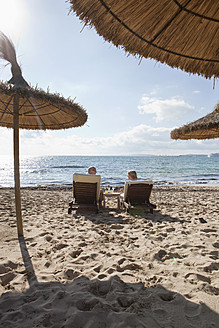 Spain, Mallorca, Senior couple on deck chair at beach - SKF000860