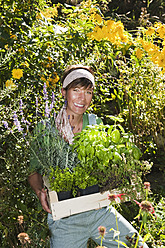 Austria, Salzburg, Flachau, Young woman in garden, smiling, portrait - HHF003863