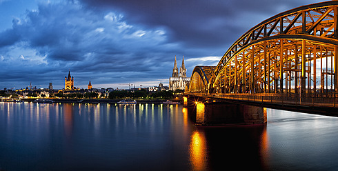 Germany, Cologne, View of Cologne Cathedral, Hohenzollern Bridge and Great Saint Martin Church with River Rhine - FOF003820