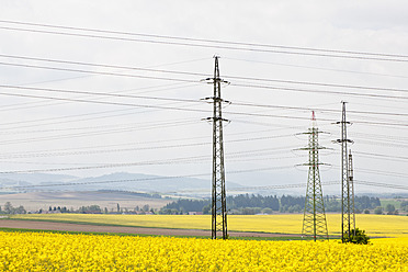 Deutschland, Bayern, Blick auf Strommast im Rapsfeld - FOF003859