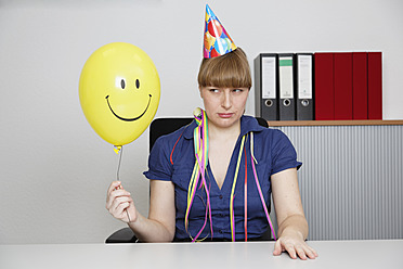 Deutschland, Geschäftsfrau hält Smiley-Ballon - ANBF000076