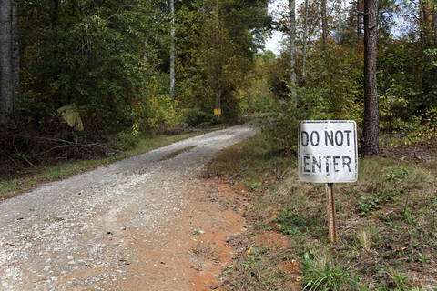USA, Georgia, Warning sign by dirt track stock photo