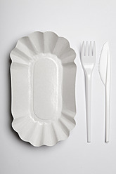 Paper plate with plastic fork and knife on white background - ANBF000024