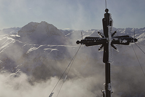 Austria, Tyrol, Kitzbuhel, View of cross with mountains in background - FFF001272