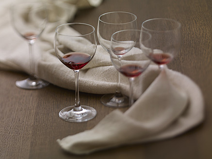 Glasses of remains red wine on table, close up - SRSF000217