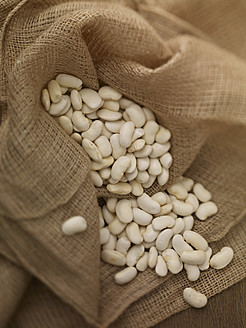 Sack of white beans on table, close up - SRSF000220