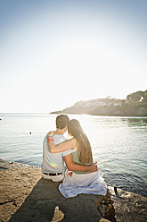 Spain, Mallorca, Couple sitting on beach - MFPF000011