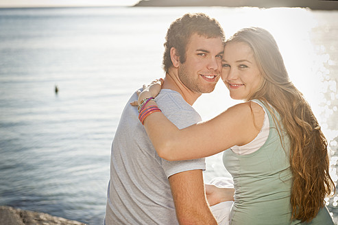 Spain, Mallorca, Couple sitting on beach, smiling, portrait - MFPF000013