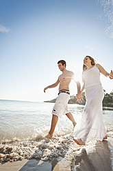 Spain, Mallorca, Couple running along beach - MFPF000023