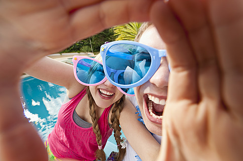 Spain, Mallorca, Couple playing on swimming pool - MFPF000054