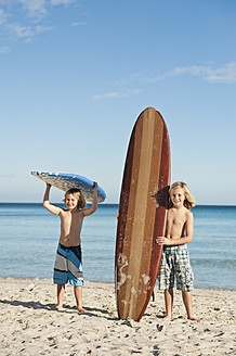 Spain, Mallorca, Children with surfboard on beach - MFPF000075