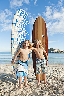 Spain, Mallorca, Children with surfboard on beach - MFPF000076