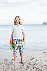 Spain, Mallorca, Boy with water gun on beach, portrait - MFPF000088