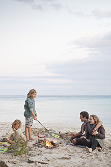 Spain, Mallorca, Friends at camp fire on beach - MFPF000116