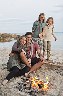 Spain, Mallorca, Friends at camp fire on beach - MFPF000122