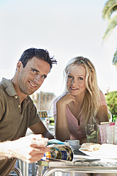Spain, Mallorca, Palma, Couple sitting at table in cafe, smiling, portrait - SKF000895