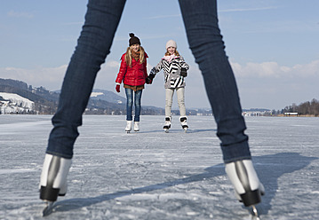 Austria, Teenage girls standing on ice rink - WWF002296