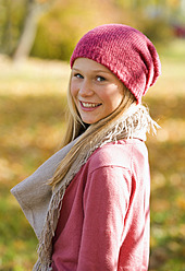 Austria, Teenage girl standing in autumn - WWF002166