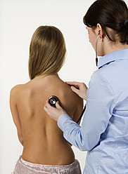 Female doctor examining teenage girl with stethoscope - WWF002179