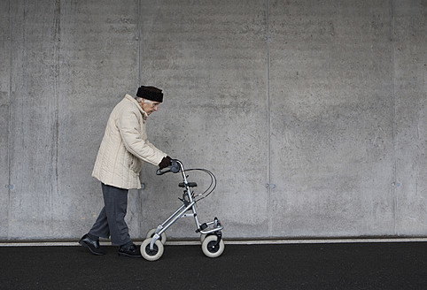 Austria, Senior woman with wheeled walker at Subway - WWF002035