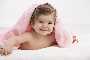 Baby girl with pink blanket, smiling - SMOF000455