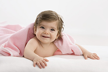 Baby girl with pink blanket, smiling - SMOF000456