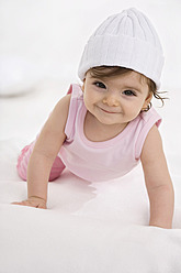 Baby girl crawling on baby blanket - SMOF000462