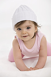 Baby girl crawling on baby blanket - SMOF000463