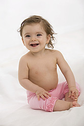 Baby-Mädchen sitzt auf Babydecke, lächelnd, Porträt - SMOF000471
