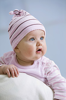 Baby girl in woolly hat, close up - SMOF000514