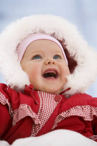 Baby girl in snow suit, smiling stock photo