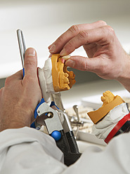 Dentist preparing dentures in dental laboratory - WWF002128