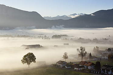 Germany, Bavaria, Kleinweil, View of village in fog - SIEF002411