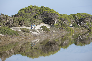 Spanien, Formentera, Älterer Mann und mittlere erwachsene Frau fahren Fahrrad - DSF000319