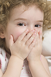 Girl covering mouth with hands - CRF002152