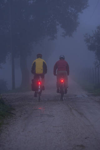 Italy, Tuscany, Mature men riding bicycle stock photo