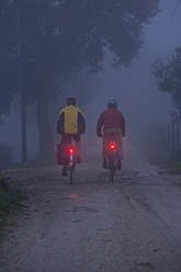 Italy, Tuscany, Mature men riding bicycle - DSF000492