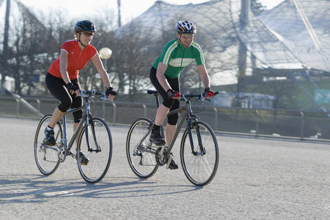 Germany, Bavaria, Munich, Man and woman riding bicycle stock photo