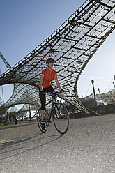 Germany, Bavaria, Munich, Mid adult woman riding bicycle - DSF000482