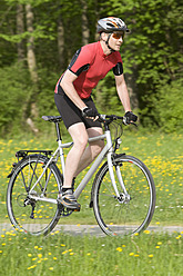 Germany, Bavaria, Mature man riding bicycle - DSF000468